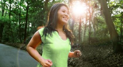 A woman running outside in the sunshine