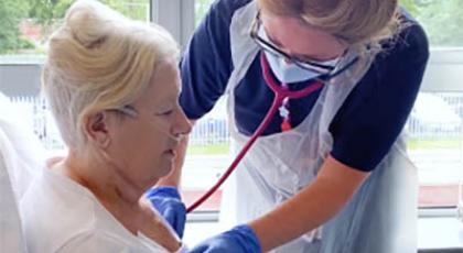 A support worker check a patient's chest